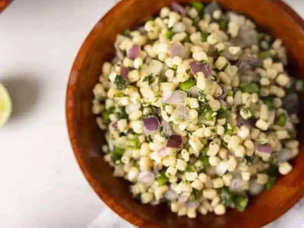 image 4080 - Everyone thinks of tomatoes when it comes to salsa, but a good corn salsa can really change up your Tex-Mex game. Perfect Corn Salsa goes even further, blowing almost any tomato salsa out of the water! Tangy, vibrant, sweet, a hint of spice, Perfect Corn Salsa has it all! Whether you're serving chips and salsa as a snack or as a topping for salads or burrito bowls, this salsa does it all!