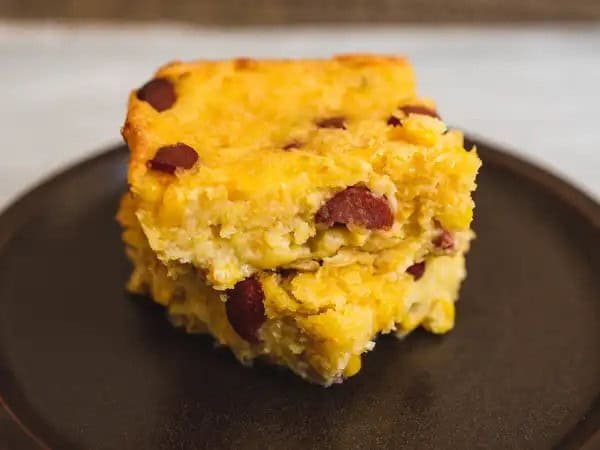 image 8516 - There’s a reason this dish wouldn’t be out of place at the local carnival: it’s basically a corn dog in casserole form! Fluffy, sweet and savory cornbread is loaded with cheese and bites of savory, wonderfully meaty hot dogs! It doesn’t take a rocket scientist to see how delicious that would be! No carnival games needed to win this Fair Favorite Bake; all you need is an oven and a touch of whimsy!