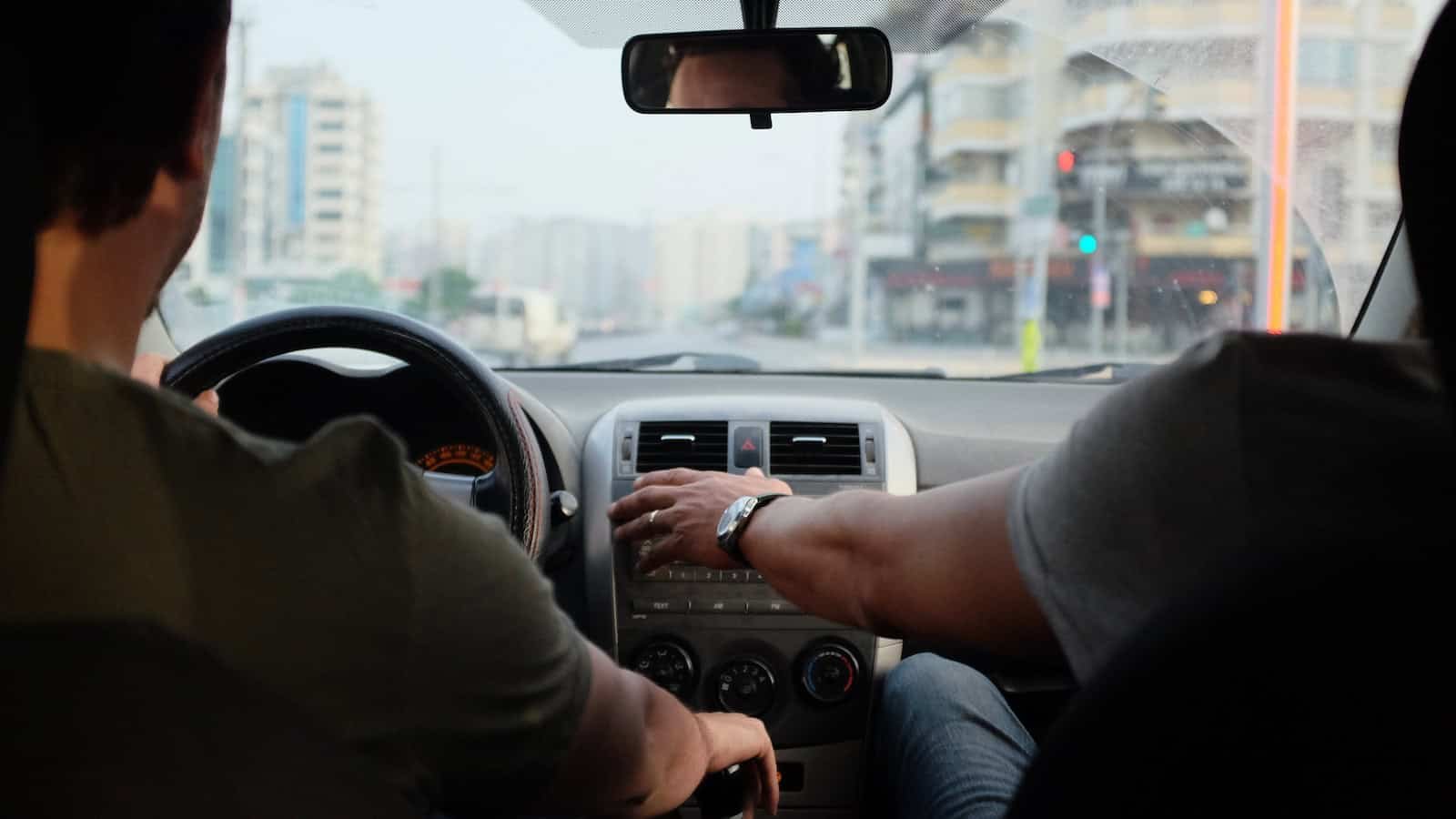 two person riding vehicle during daytime