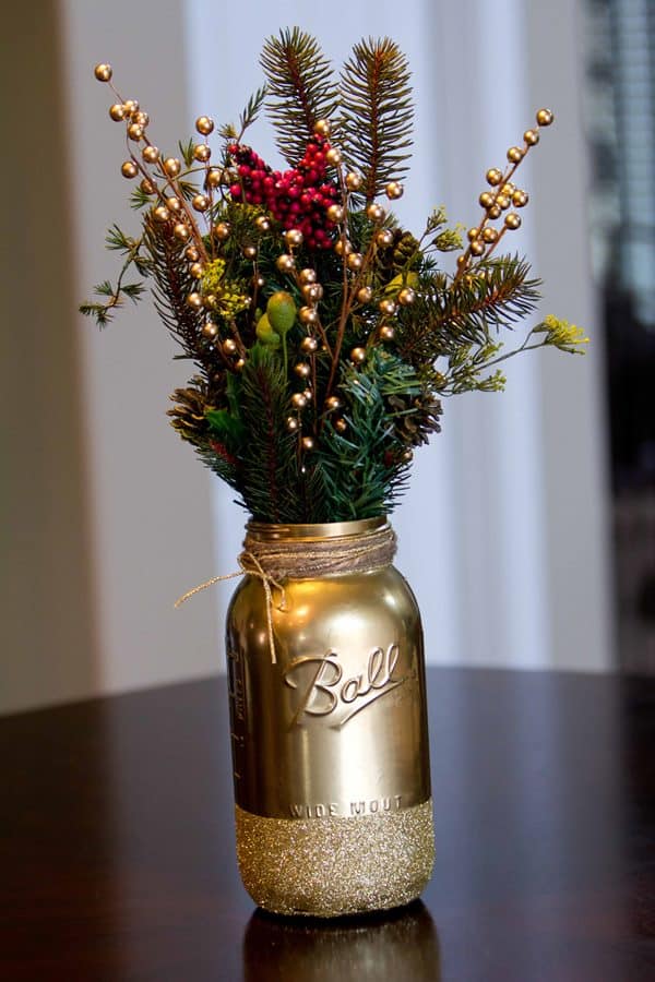 29. Christmas DIY Gold Glitter Mason Jar - These Christmas crafts with mason jars are ideal for anyone who enjoys crafting indoors while the winter chill keeps them inside.