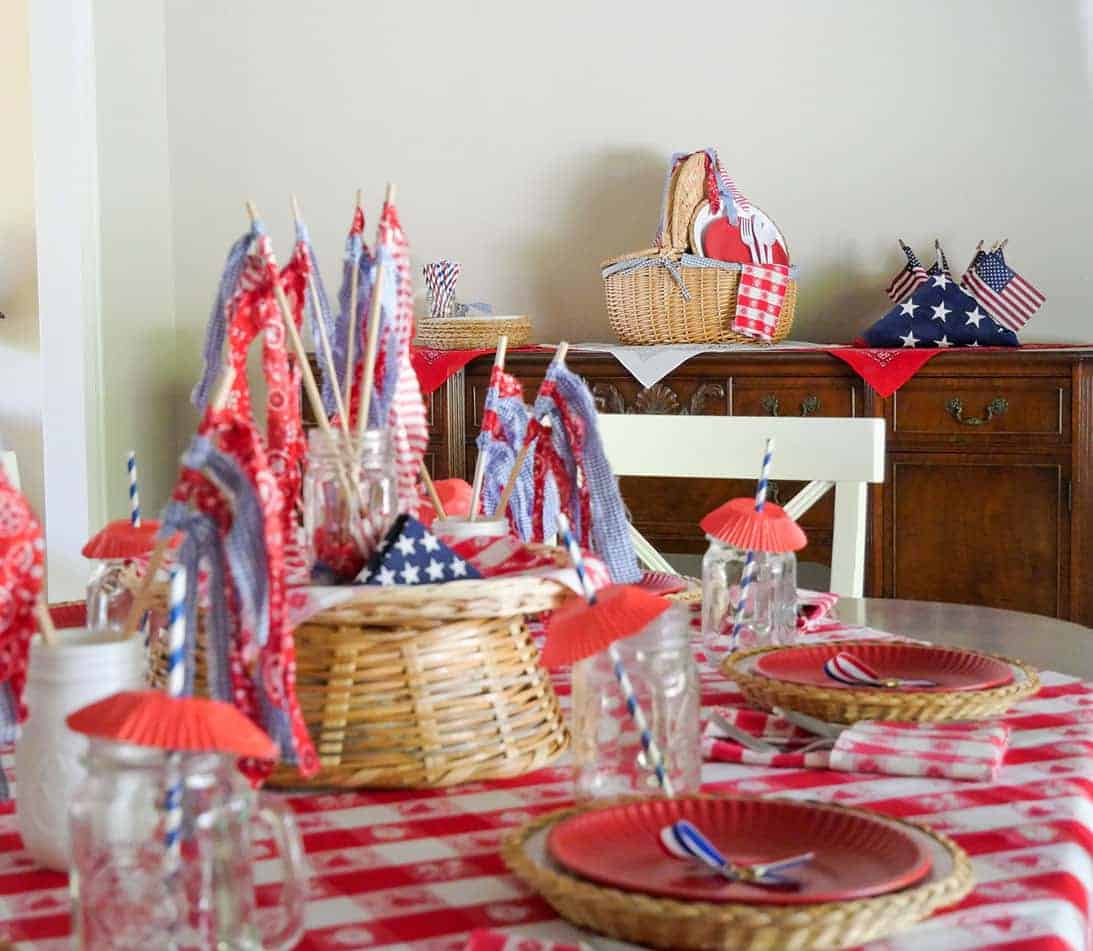 Memorial Day table setting centerpiece to back 2 - Prepare for Memorial Day festivities with these exquisite Memorial Day decorations! From patriotic banners and flags to homemade centerpieces and table arrangements, we have everything you need. Establish a celebratory ambiance with these straightforward yet captivating suggestions. Explore our array of inspiring concepts and gear up to display your American patriotism!