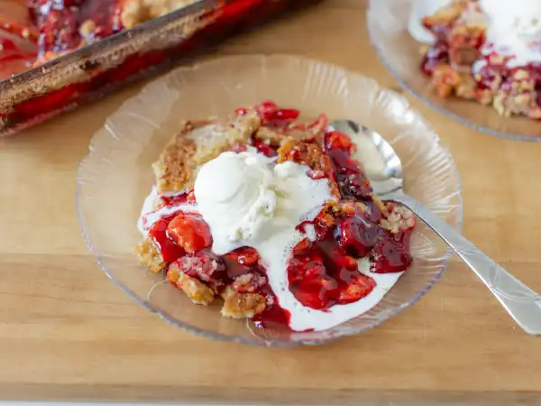 2 97 - When a dessert explodes with flavor, you just know it's a treat you'll want on repeat! Versatile and easy to love, Cherry Eruption Cake will become a fast favorite, especially for those who, ahem, don't absolutely love baking. So, wave goodbye to complex sweets, because this one is so easy to pull together. Just grab a couple cans of tangy, sweet cherry pie filling, the always-on-hand yellow cake mix, some melted butter, and a dash of amazing almond extract and immediately the vanilla ice cream everywhere will be screaming for joy to join in the fun! This explosively, easy-peasy concoction we call Cherry Eruption Cake is the great flood of flavor you've been waiting for. In a flash, you will be gushing from all the compliments to the baker!