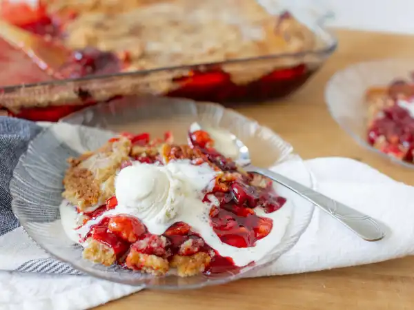 3 78 - When a dessert explodes with flavor, you just know it's a treat you'll want on repeat! Versatile and easy to love, Cherry Eruption Cake will become a fast favorite, especially for those who, ahem, don't absolutely love baking. So, wave goodbye to complex sweets, because this one is so easy to pull together. Just grab a couple cans of tangy, sweet cherry pie filling, the always-on-hand yellow cake mix, some melted butter, and a dash of amazing almond extract and immediately the vanilla ice cream everywhere will be screaming for joy to join in the fun! This explosively, easy-peasy concoction we call Cherry Eruption Cake is the great flood of flavor you've been waiting for. In a flash, you will be gushing from all the compliments to the baker!