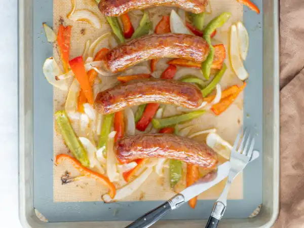 1 137 - The Juicy Sausage Sheet-Pan Dinner brings sausages, peppers, onions, and tomatoes together. How can things get better? Savory sausages mingle with bright and delectable veggies, with wonderful caramelized bits for extra crunchy flavor. It's rustic, simple, and so easy to make! Perfect! Juicy Sausage Sheet-Pan Dinner will make dinner as breezy as it should be!