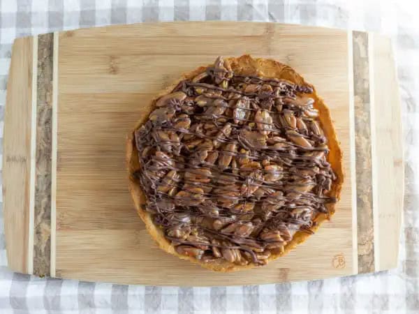 image 10660 - Break out of your dessert shell and try this today! Tasty Turtle Tart is hard to beat when it comes to all of the great tastes it delivers. A flaky pie crust holds together a caramel-y pecan filling all topped with a chocolate drizzle that really ties it all together. So, slow down, grab a plate, a slice, and maybe some whipped cream and let this Tasty Turtle Tart show you how things can feel on the slow side of town. Doesn't that all sound delightful? Coffee, anyone?!