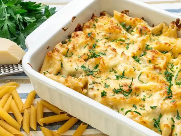 image 11031 - Ever catch yourself daydreaming about cheese? Well, make your dreams a reality with this Easy Cheesy Chicken Alfredo Bake — the most perfect creamy creation that literally embodies everything your cheesy dreams are made of! When tender penne pasta, savory diced chicken, and an incredible garlic-infused, parmesan and mozzarella cheese-ladened Alfredo sauce comes together, you'll be living out your delightful dairy dreams. When a quick, dreamy, delicious dinner is on your mind, Easy Cheesy Chicken Alfredo Bake will lay to rest any reservations you may have about making a homemade Italian dish. It's everything you ever dreamed of!