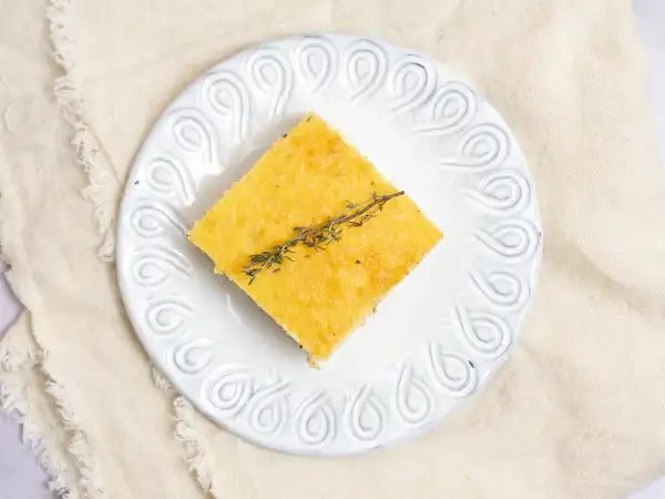 image 11483 - Special Spoon Bread Bake sounds like something that would come straight from your grandma's Southern kitchen, don't ya think? It brings a little bit of elegance with a whole lot of comfort, which really reminds us of our dear granny. This golden-brown dish is buttery, warm, and thick to create a consistency that is partially bread-like, but with a nod to a creamy soufflé. She would probably serve Special Spoon Bread Bake alongside some fried chicken, green beans, and mashed potatoes and we think that sounds like quite a delicious feast. Don't you? Make a plate and see for yourself!