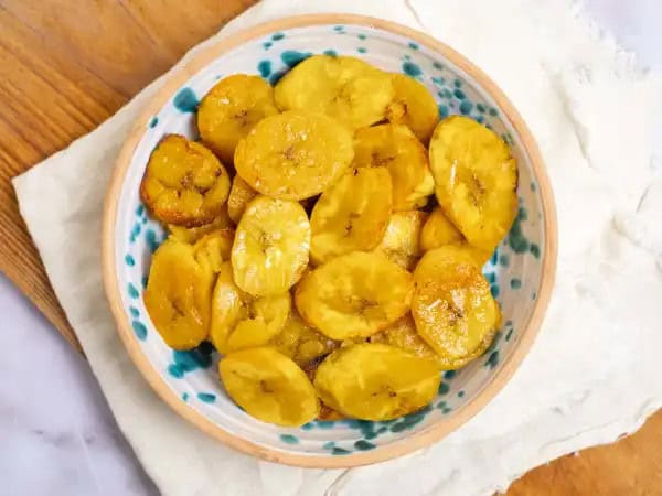 image 11529 - It's your lucky day! You have stumbled upon the best snack ever! These Perfect Baked Plantains are so delicious. They're just the right amount of sweet with the most satisfying amount of salt. The edges bring a tiny bit of crispy crunch, and the insides are amazingly tender. And the best part is they're good for your body... providing you with a yummy, healthy, carb-filled snack with all the good kinds offiber, vitamins, and minerals. Perfect Baked Plantains can't be beat! You're in for a real treat with these little guys!