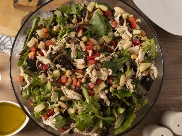 image 11583 - When it's Wednesday and you want a great salad without the restaurant baggage, Easy Mediterranean Salad will fit perfectly into your weekly menu! When you combine shredded chicken, hearty chickpeas, fiber-rich cannellini beans, crisp English cucumbers, crunchy red bell peppers, tangy Kalamata olives, earthy artichokes, and fresh mixed greens tossed with a lemon-infused olive oil dressing, you can really feel that fresh-from-the-garden joy. Easy Mediterranean Salad is a journey for the taste buds that won't leave you hungry.