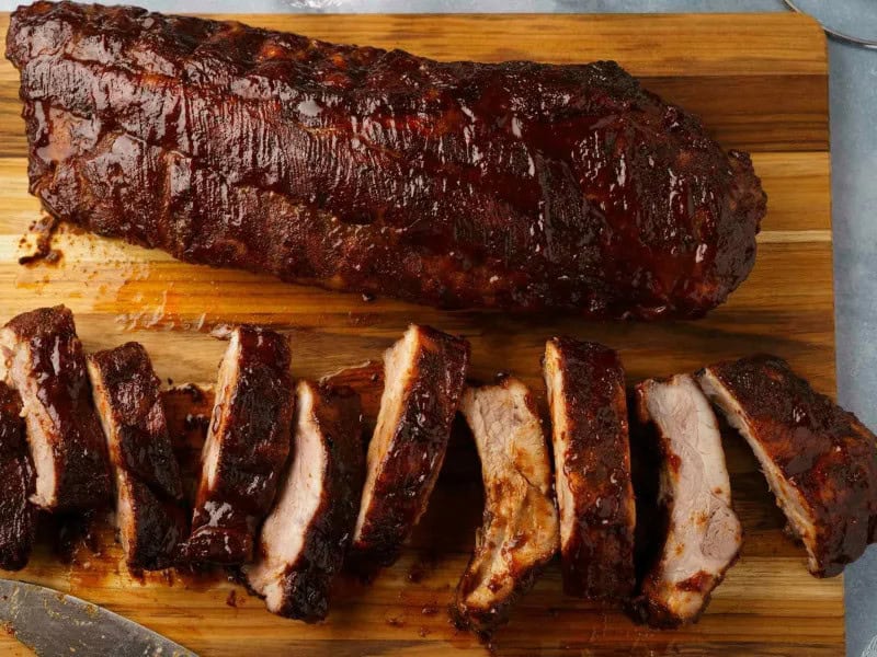 image 12123 - Step away from the grill and into your kitchen–it's time to make some Rain or Shine Oven BBQ Ribs! Two hearty racks of ribs get generously seasoned with hints of caramel-y brown sugar and fragrant garlic. These flavorful racks then take a nice long bake in the oven to ensure every inch is tender. Sounds amazing, right? Well, it keeps going! The beloved, juicy pork gets smothered in your favorite tangy and smoky barbecue sauce, not once but twice baked to infuse every ounce of the meat with classic cookout flavor. Your mouth has to be watering by now. Come rain or shine, you can always count on the deliciousness that Rain or Shine Oven BBQ Ribs will bring!