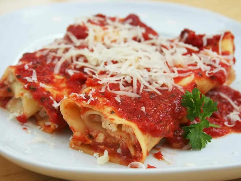 image 12126 - Quick and Easy Manicotti is a hearty Italian dish that is perfect for dinner any night of the week! In Italian, manicotti means "little sleeve.” These little sleeves are stuffed with garlic, beef, and cheese, and covered with marinara sauce. Make Quick and Easy Manicotti for a cheesy, savory meal that’s so delicious, you’ll feel like you’re at an Italian restaurant!