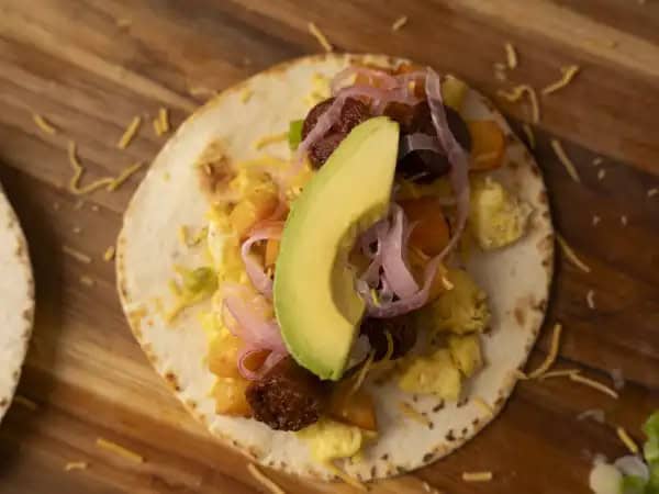 image 13086 - When you're tired of eating waffles or bland bacon and eggs are making you yawn, wake up with excitement with these Simple Breakfast Tacos! There will be no more hitting snooze when you know you've got warm tortilla shells full of spicy chorizo sausage, tender potatoes, fluffy eggs, and all the fixin's waiting to be made up in the kitchen! Once the sandman works his magic, you'll be waking up to something just as deliciously dreamy. Simple Breakfast Tacos will make every morning feel like a slumber party!