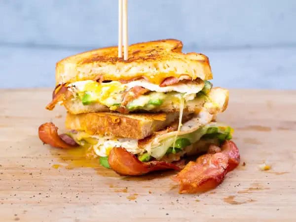 image 13392 - Your childhood grilled cheese is getting a mega upgrade! Each bite of this Supreme Grilled Cheese has all that melty, gooey cheese that you're so familiar with, but it's all grown up now. Add some crispy bacon, hearty avocado, and a runny egg and you've got yourself a delicious adult-version that you'll love just as much... honestly, probably even more! Did we mention this calls for some creamy Muenster cheese AND shredded sharp cheddar?! None of that fake, questionable stuff is allowed on these slices. Supreme Grilled Cheese is the grilled cheese of all grilled cheeses. Growing up has never tasted so good!