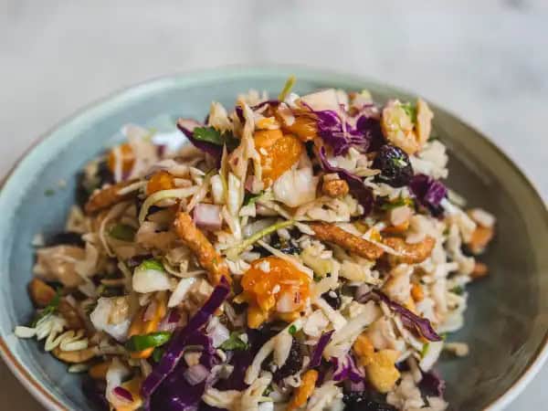 image 13456 - There's a lot of crunch to go around when this Asian Chicken Salad is on the table! Coleslaw, toasted almonds, sesame sticks... you can hear this salad for miles, and it sounds good! But of course, that's not all there is to Asian Chicken Salad! Sunny oranges, savory chicken, and a sweet, soy-sauce-infused dressing really makes this a flavor feast all around! This can be made in a snap, which is good because you might just find yourself craving more of it after the first bite!