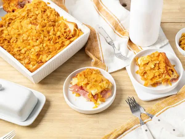 image 13542 - There is profound respect for a long heritage of well-made food. Layered Amish Bake comes from that well-known lineage, and we know you will love it! Savory ham and white bread are layered with loads of cheddar cheese and a fluffy egg mixture. To add to the tasty tradition, it's topped with a cornflake coating for a great way to start the morning or even a great brunch. Layered Amish Bake stacks up to be one of the best breakfast casseroles in history! Yum!