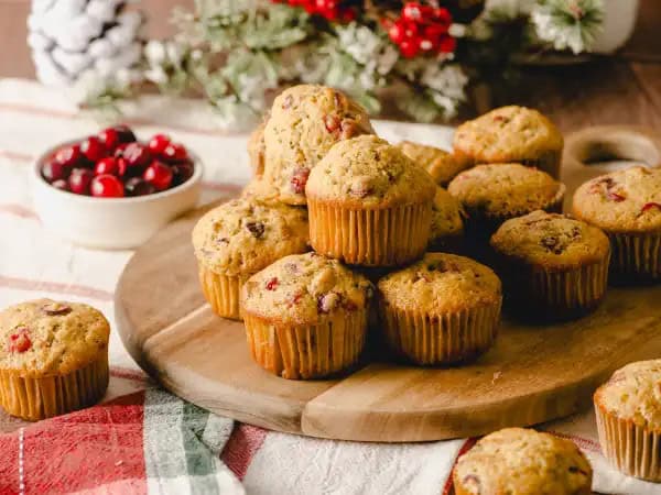 image 13698 - Santa will definitely be heading down your chimney first with the smell of this sweet treat wafting from your kitchen! Christmas Eve Muffins will be a grand reminder of golden days long past and a promise for golden days yet to come. Loaded with tart cranberries and crunchy pecans, these moist muffins have a citrus orange zest about them that make them simply irresistible. We aren't sure if you've been naughty or nice, but we do know that you won't be able to eat just one of these Christmas Eve Muffins. Just please make sure you leave a couple out for the Big Guy!