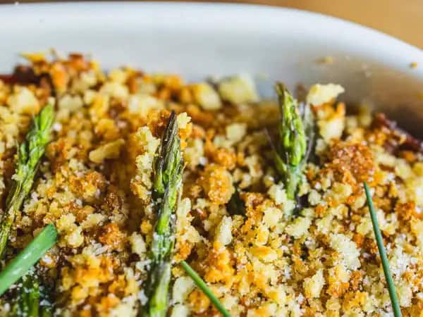 image 13764 - Homemade toasted breadcrumbs. Garden-fresh asparagus. Creamy potatoes. It all comes together to make this Delicious Side Dish Bake... and the name alone tells you everything you need to know! The top is crunchy, the cheese sauce is sharp and rich, and the prosciutto is salty and succulent, adding another dimension to an already exceptional side dish! Delicious Side Dish Bake is perhaps even better than the name suggests!