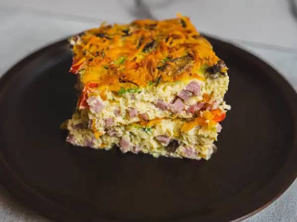 image 14016 - If it's brunch time, then it's time for a savory star like this Classic Breakfast Bake. It's as simple as that! A fluffy, creamy bed of eggs filled with savory ham, beefy mushrooms, and crunchy green onions is exactly what the morning needs to feel truly exciting! A blanket of cheese on top certainly never hurts either! The Classic Breakfast Bake is how you start your day off on the right foot!