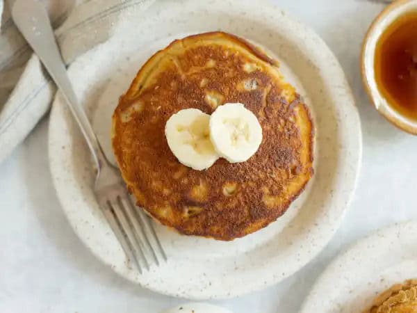 image 14190 - The rich, tropical, creamy flavor of banana is infused into each bite of the Best Banana Bread Pancakes; in fact, that's part of why they are the best! The fact that these fluffy treats are so light and sweet and packed with crunchy walnuts before being pan-fried in butter is the other (very good) reason! The Best Banana Bread Pancakes taste like the best of both worlds, and breakfast will never be the same!