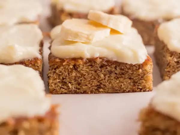 image 14297 - Banana Bread Bars have an alliterative appeal that matches their delicious decadence! The cake itself is moist and flavored with the ethereal and tropical sweetness of banana. On top of the cake is a luscious, tangy, and rich cream cheese frosting, making Banana Bread Bars a dessert that compels you to just keep eating more of it! Bite into these bars and benefit from their beautiful flavor!