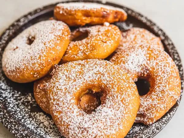 image 14387 - These donuts are a refreshing take on a classic! Crispy Apple Fritter Rings are battered and fried apples, so they're moist but still crunchy, crisp and filled with sweet tartness. Coated with powdered sugar and warm cinnamon, Crispy Apple Fritter Rings are an energizing, carnival-style snack that you could eat any time, even for breakfast! And why not? They have apples in them, after all!