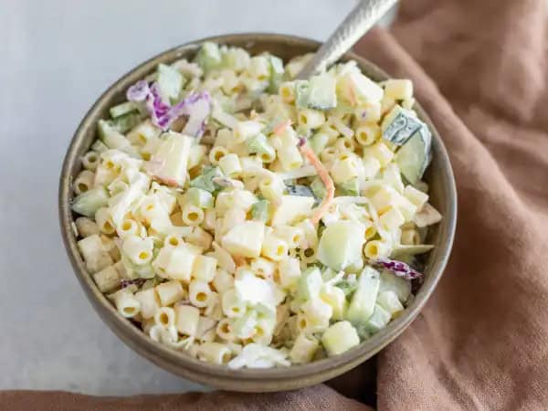 image 14436 - Summer is not complete without a couple bowls of coleslaw and pasta salad. Or a few... or 12. Well, this Summer Pasta Slaw is so good even 12 bowls of the stuff might not be enough. We combined two beloved summer salad sides into one, and it will blow your mind! Tender macaroni, crunchy coleslaw mix, crisp apples, and juicy cucumbers make up the refreshing and cool side salad, but the heart-and-soul of the dish is obviously the dressing. That dressing is creamy, tangy, sweet, and a perfect way to bring out the most of the fresh flavors. Summer Pasta Slaw is the perfect way to beat the heat!