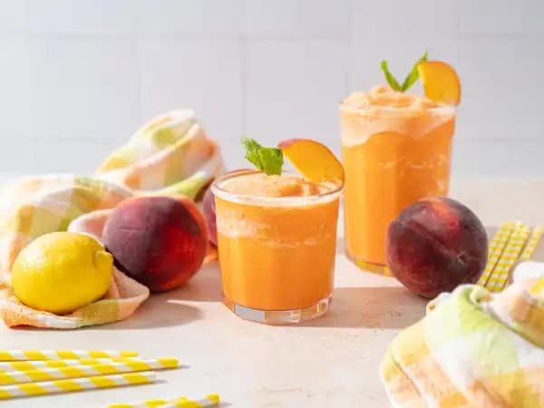 image 14440 - This drink isn't just cool in a temperature sense; it's pretty fashionable to boot! Frozen Summer Sipper combines the sunny goodness of zesty lemonade with the floral, indulgent summer delectability of peach in an icy, refreshing brew. Just blend, freeze, and presto! The heat just melts away! This Frozen Summer Sipper will have you enjoying the best the season has to offer, and in a jiffy!