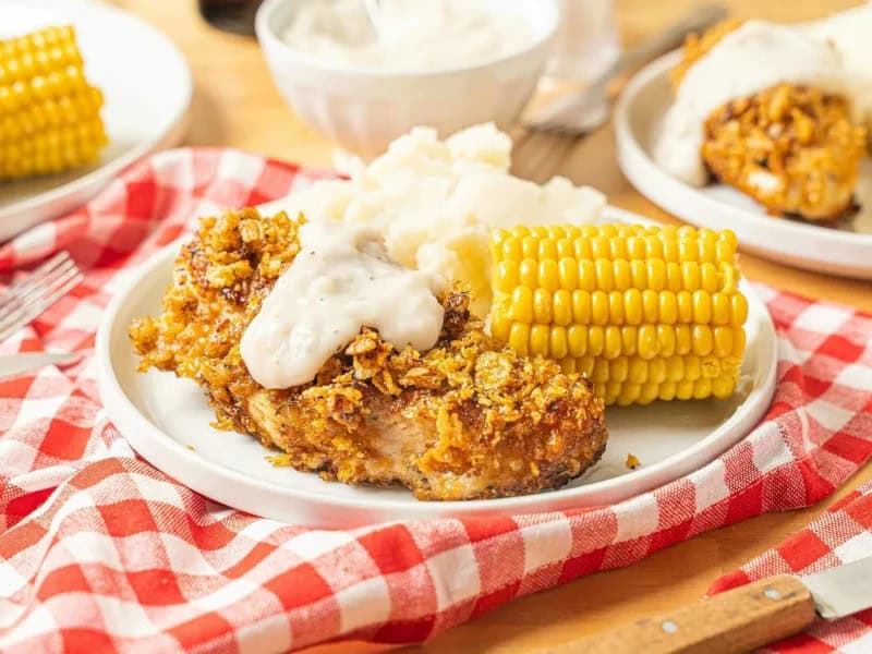 image 14607 - It doesn't get more comforting than Country Chicken and Gravy, especially on a cold night. The gravy alone is like a blanket of creamy, buttery, savory flavors that will get your soul warmed up! The chicken is truly crunchy, with a beautifully seasoned crust that locks in the juiciness and the savory taste. Country Chicken and Gravy is perfect for getting you warmed up and energized for whatever tomorrow brings. Best of all, you can finish cooking in just half an hour, so you can enjoy this meal without breaking a sweat!