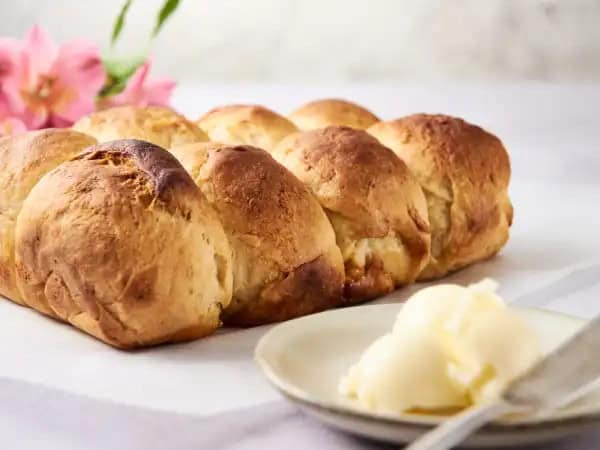 image 14694 - To-Die-For Hawaiian Rolls are little pieces of paradise you'll want to keep popping into your mouth! These buttery, tender rolls are infused with the tropical tang of pineapple, bringing a little of the Hawaiin feeling to every meal! Brushed with sweet, rich honey butter and baked to a golden-brown, To-Die-For Hawaiian Rolls really are to die for!