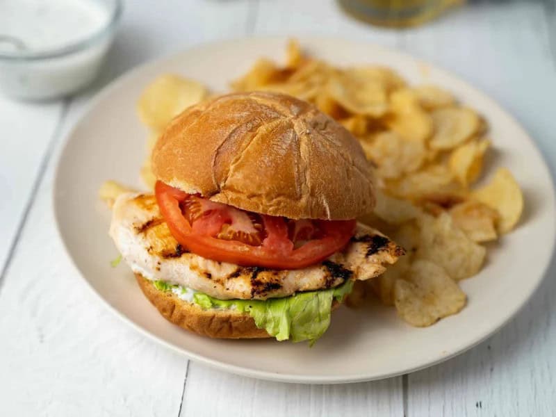 image 14906 - Let the only labor you do today be whipping up these Labor Day Sandwiches and psst, it takes less than 25 minutes! So you'll be munching on a juicy, perfectly seasoned grilled chicken cutlet topped on a fluffy, ranch-coated kaiser roll in no time! You can't forget the spicy Pepper Jack cheese, crispy lettuce, and sweet tomato piled on top. And it wouldn't be a proper sandwich without a heaping side of your favorite salty, crispy potato chips! They say you'll never work a day in your life if you love what you do, and you'll experience that after cooking and chowing down on some Labor Day Sandwiches!