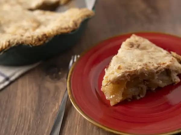 image 15193 - Apple Cheddar Pie is a great way to introduce skeptics to the ever-rewarding pairing of fruit and cheese! The sweet jamminess of the apples makes a wonderful contrast to the salty, sharp, creamy flavor of the cheddar. The lovely, warming autumnal spices of traditional apple pie also marry beautifully with the beloved cheese, as does the buttery, flaky homemade pie crust. There's endless rustic charm to this Apple Cheddar Pie, and its balance of sweet and savory will have you constantly coming back for more.