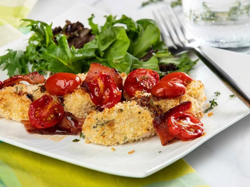 image 15420 - Here's a savory summer spectacle to rival the classic chicken-bacon-ranch combo! Tomato Bacon Chicken still brings the crunchy, juicy breaded chicken and fatty, crispy bacon, served with bright, tangy, and smoky tomatoes that burst with sunshine flavor. The tenderness of the tomatoes provides a lovely contrast to the crunch of the chicken and bacon, while also adding a note of refreshment that will have your mouth watering. You can even make Tomato Bacon Chicken in half an hour or less, speeding you to a satisfying meal with seasonal flare. It's relaxation on a plate!
