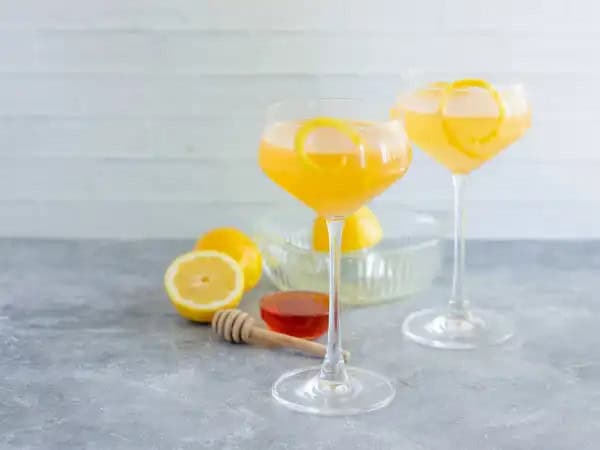 image 15511 - See what the buzz is all about with this hive of happiness in a glass! The Bee's Knees is a blend of fabulous classics that come together for the perfect, refreshing adult treat. Let the rush of freshly squeezed lemons with a touch of honey swirl you with delight. A generous drop of gin will transport you to a wonderful summer escape. Light and airy, The Bee's Knees is, well, the bee's knees of cocktails. And honey, we are not embarrassed to buzz all about that!