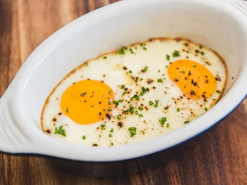 image 15547 - Who says you must cook your eggs on the stove-top? Baking them in the oven actually allows you more control over this perennial, sunny, breakfast protein, which enables you to achieve your favorite level of perfect, runny, rich yolks. These Simple Baked Eggs don't need much time, energy, or even that many ingredients. It allows the eggs to be the hero of the dish and lets them shine! No more splatter and no more stress with Simple Baked Eggs on the menu this morning!