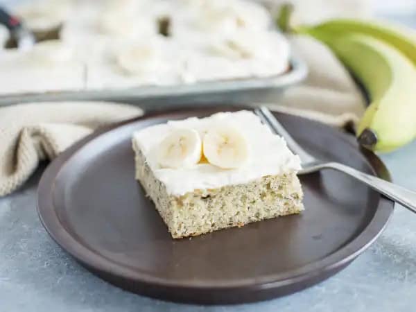 image 16237 - You'll go nuts for these Banana Bars with Cream Cheese Frosting... and not just because they have crunchy pecans mixed in! The creamy, fruity banana flavor is infused into each bite of the tender cake, and is accented by the warm aroma of cinnamon. Meanwhile, all over the top is a creamy, luscious, tangy cream cheese frosting that makes each bar delectable and desirable. Oh yes, Banana Bars with Cream Cheese Frosting are perfect for sharing or for keeping all to yourself!