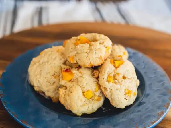 image 16339 - If peach cobbler makes you feel rather peachy, well then, these Cobbler Cookies are definitely going to have the same effect! Imagine biting into that golden, fluffy, and sweet cobbler goodness you love so much without having to use any type of utensil! What a dream, eh?! This preparation makes it so that Cobbler Cookies can basically be eaten anywhere! Your favorite, peach-filled treat can be there to delight you no matter where you are! How fun?!