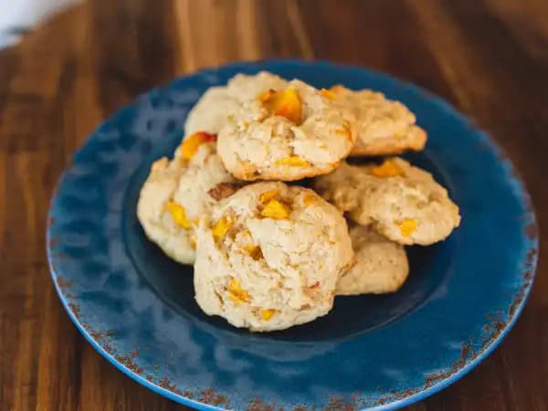 image 16340 - If peach cobbler makes you feel rather peachy, well then, these Cobbler Cookies are definitely going to have the same effect! Imagine biting into that golden, fluffy, and sweet cobbler goodness you love so much without having to use any type of utensil! What a dream, eh?! This preparation makes it so that Cobbler Cookies can basically be eaten anywhere! Your favorite, peach-filled treat can be there to delight you no matter where you are! How fun?!