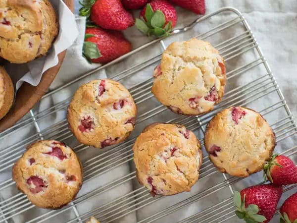 image 16680 - Nothing beats waking up to a beautiful sunny day in the summer. There really isn't a more optimistic moment: the whole day stretched out before you, just waiting for you to take your first step. For breakfast on a morning like this, you need something just as bright and cheerful: Strawberry Muffins. Dotted with the ruby jewels of fruit, buttery and tender and sweet, these confections are delights to eat and are fairly easy to make too! Strawberry Muffins taste like summertime and bring on the smiles. Everything is looking up!
