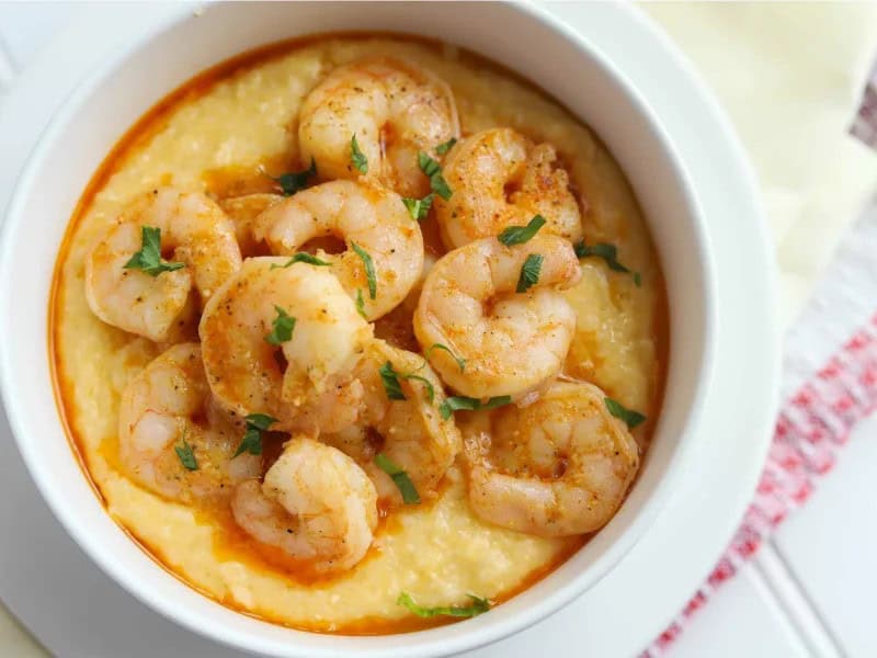 image 16850 - A classic of Southern cooking comes to your kitchen! Southern Shrimp n' Grits serves up creamy, rich, and cheesy grits infused with seafood flavor. Sweet shrimp coated in a savory, aromatic, and spicy mix of herbs and sauces tantalizingly invite you to sit down and enjoy this to the fullest. Since you can plate Southern Shrimp n' Grits in just 35 minutes, you can find the time to make it no matter how hectic your schedule; it's the welcome moment of relaxation you need when things get busy!