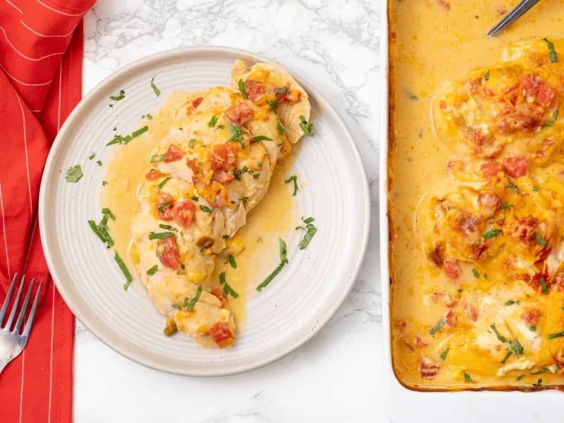 image 16872 - Bland chicken should have no place in your kitchen, not while Queso Chicken exists! This dish combines nacho-style melted cheese and tender chicken for the ultimate meaty and melty delight. Topped with juicy tomatoes and spicy chiles, Queso Chicken is almost unbelievable in its decadence. Queso Chicken is so hearty and tasty, it’ll become your new favorite Tex-Mex meal.