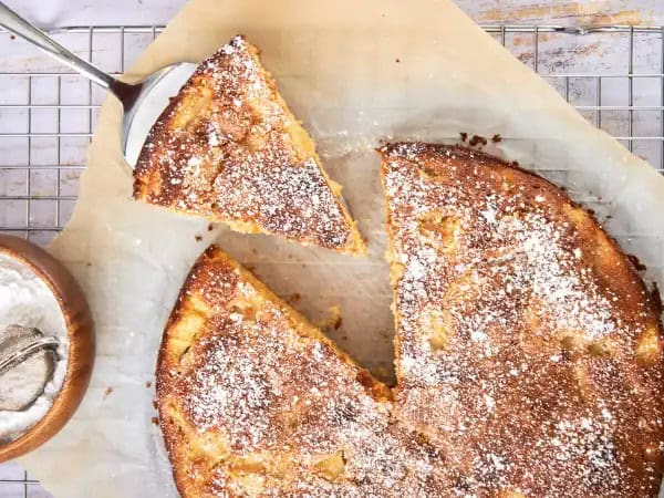 image 171 - From the banks of the Seine to your table, this elegant dessert is everything you could want in a slice of cake! Famous French Apple Cake is buttery and tender, infused with the sugary bite of rum and plenty of jammy, juicy apples. Dusted with confectioners' sugar, Famous French Apple Cake is the perfect amount of sweetness and charm. It's like a visit to the French countryside for your taste buds!