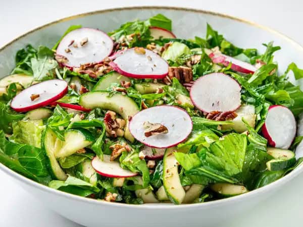 image 18267 - Mean Green Salad is a nice way to perk up your lunches, and makes just enough to easily share with everyone (if you're inclined to share)! Crisp arugula and crunchy lettuce are delightfully loaded with spry radishes, packs-a-crunch cucumbers, and buttery pecans, and then it's all topped with a touch of refreshing mint drizzled with a tangy balsamic dressing. Quench your hunger with Mean Green Salad and let your happy emotions run wild!