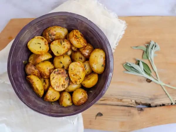 image 18327 - If you love potatoes like we do, you can never have too many great recipes on your potato recipe list! Best Oven Baby Potatoes will quickly find its way to the top of your faves in just one sitting. Loved by basically everyone, these baby potatoes are generously seasoned and then roasted to fork-tender perfection. Served with steak, chicken, or pork, Best Oven Baby Potatoes are a friendly companion to all. It's always great to find new flavor friends!