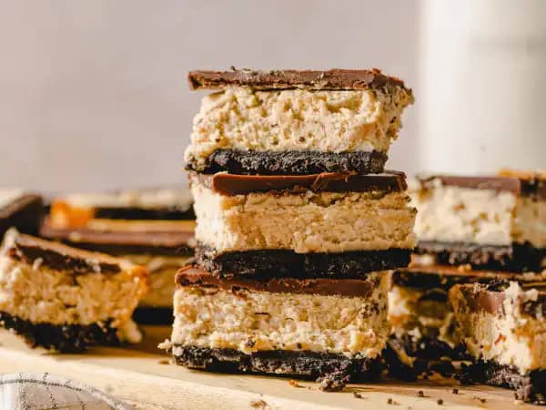 image 1845 - If you're a peanut butter enthusiast, well hey, welcome. You're right where you're meant to be on the internet. The stars have aligned just perfectly for you to get to experience these Peanut Butter Cheesecake Bars. Really! The way the crunchy, chocolatey crust holds the rich peanut butter cheesecake that's topped with a smooth layer of sweet chocolate is basically a miracle... and you get to benefit from this supernatural phenomenon. Some things just work out the way they should and that is always the case with these Peanut Butter Cheesecake Bars!