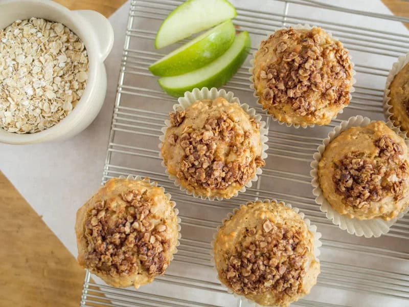 image 18511 - Mmm, Apple Cinnamon Oatmeal Muffins. There really isn't too much more to say about these since their name alone prepares you for what you're about to bite into... but we'll expand on that some more anyways. These soft and crumbly muffins are filled with hints of sweet brown sugar, rich cinnamon, and tart apple. On top there's some crumbly and sugary goodness sprinkled all over, because how could there not be?! Apple Cinnamon Oatmeal Muffins give you just what you'd expect and then some!