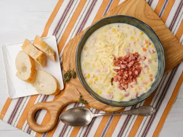 image 18586 - Great chowder in an hour isn't impossible; in fact, it's deliciously achievable with this Quick & Easy Cheesy Ham Chowder! The broth is creamy and savory, and filled with succulent ham and crisp bits of bacon for an extra pork kick! Loaded with cheese, potatoes, and sweet summer corn, the Quick & Easy Cheesy Ham Chowder is a warm weather favorite that tastes bountiful and looks beautiful!