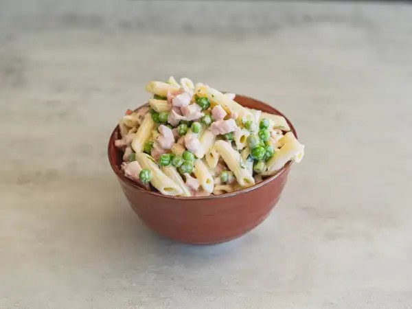 image 18851 - Spring Ham & Pea Pasta Salad is the perfect addition to your seasonal menu! This refreshing and flavorful side dish features tender pasta, succulent ham, and sweet peas, all tossed in a creamy and herbaceous dressing. This dish is loaded with fresh and vibrant ingredients that will remind you of all the sunny days ahead. It's the best way to showcase the flavors of the season and is ideal for a family gathering or a picnic in the park. Spring Ham & Pea Pasta Salad is the perfect light dish to ring in the season of warm weather and blooming flowers coming your way!