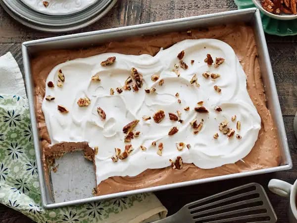image 18882 - What is a Chocolate Pecan Casserole, you might be wondering? Dessert casseroles aren't quite as common as the savory ones, we know. Well, first thing's first, it's delicious. Okay, okay, we bet you need to know more than that. Well, think of it like this... it's a large baking dish lined with a crunchy pecan-filled crust that's holding a creamy, chocolate filling and topped with rich whipped cream and even more pecans! Um, yum! Sounds like quite the treat, right? Perfect for all your gatherings, from birthdays to holidays, Chocolate Pecan Casserole is just the best dessert to ever be!