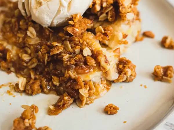 image 19919 - This is the Best Banana Bread Cobbler, although it might also be the first and only time you've ever seen such a thing! It's like banana pudding, bread pudding, and fruit cobbler all collaborated on a dessert that offers up the best of themselves! It features the creaminess and subtle, but tropical, flavor of a banana pudding, the tender texture and sweetness of a bread pudding, and the crunchy, nutty topping of a cobbler, all in one dish! With a scoop of ice cream on top, Best Banana Bread Cobbler is ready to take over the world of desserts and prove itself to be THE best!