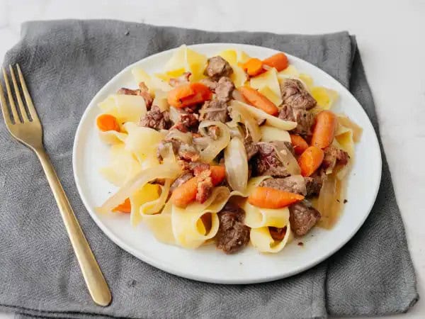 image 19928 - If you're craving a meal that's warm and cozy and brings some of that stick-to-the-ribs kind of heartiness, well, you're in the right place. This Drunken Beef Stew is the best dish to serve up when the weather is chilly, and your belly is hungry. Fill your bowl high with this tender, savory meat-and-veggies concoction layered atop your favorite bouncy noodles. This is the kind of meal that'll leave you wanting seconds because it's just that good (disregarding any concerns about there not being enough room for round two). Know the feeling? Get ready to experience ALL the good things with this Drunken Beef Stew!